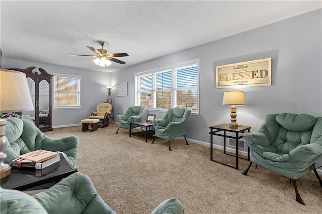 living room with a ceiling fan, carpet, baseboards, and a textured ceiling