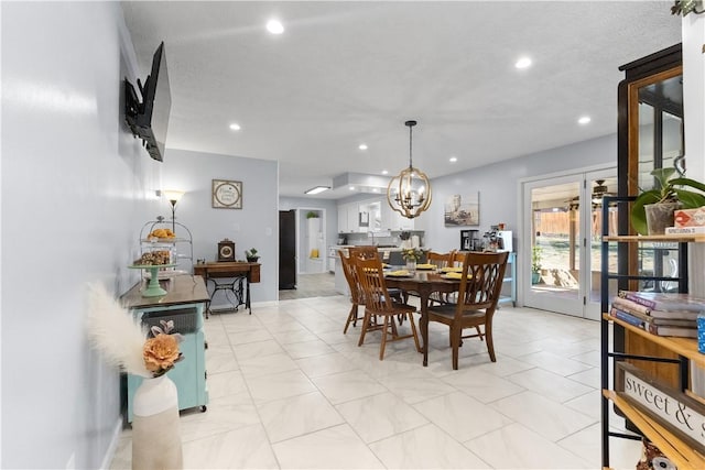 dining area featuring recessed lighting and a chandelier