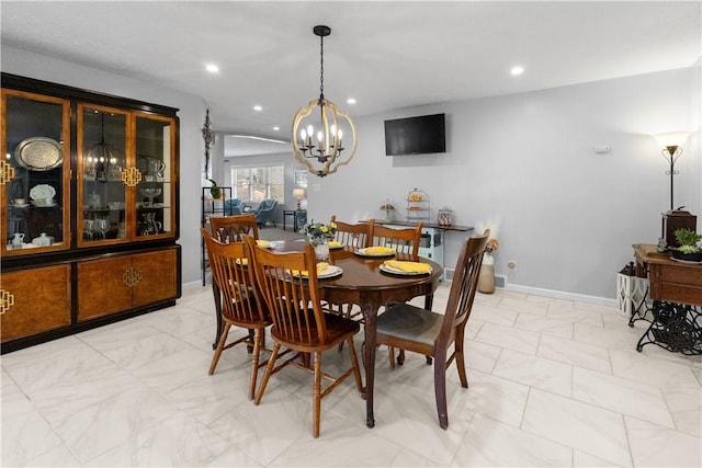 dining area with a notable chandelier, recessed lighting, baseboards, and marble finish floor