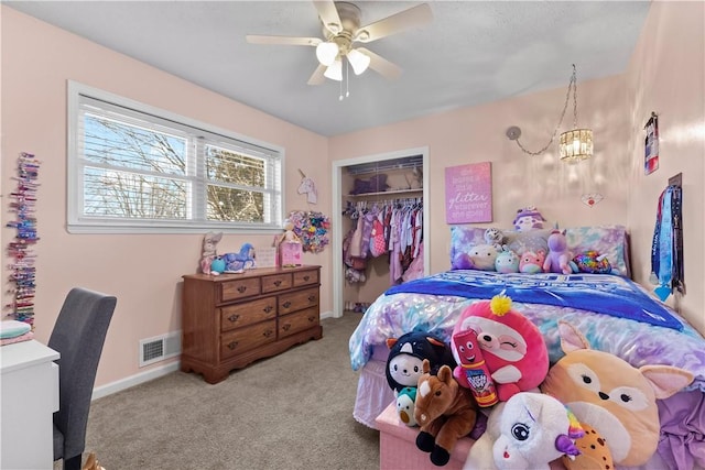 carpeted bedroom featuring a closet, visible vents, a ceiling fan, and baseboards