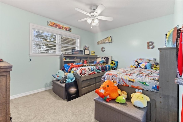 carpeted bedroom featuring baseboards and ceiling fan