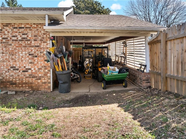 view of vehicle parking featuring fence