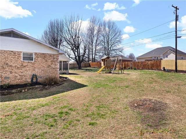 view of yard featuring a playground and a fenced backyard