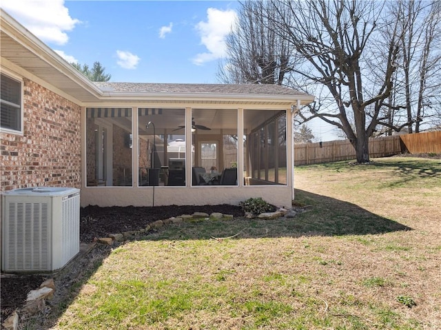 view of yard with cooling unit, a sunroom, and fence