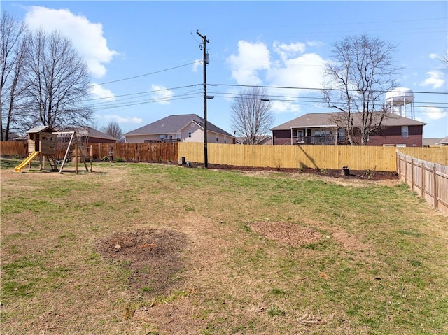 view of yard with a playground and a fenced backyard