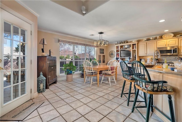 dining space featuring light tile patterned floors, baseboards, recessed lighting, crown molding, and a chandelier