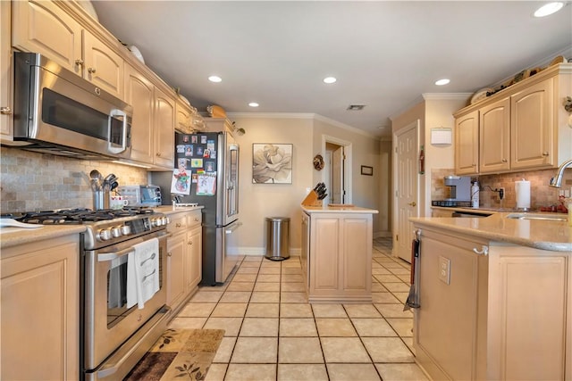 kitchen with light tile patterned flooring, a sink, light countertops, appliances with stainless steel finishes, and crown molding