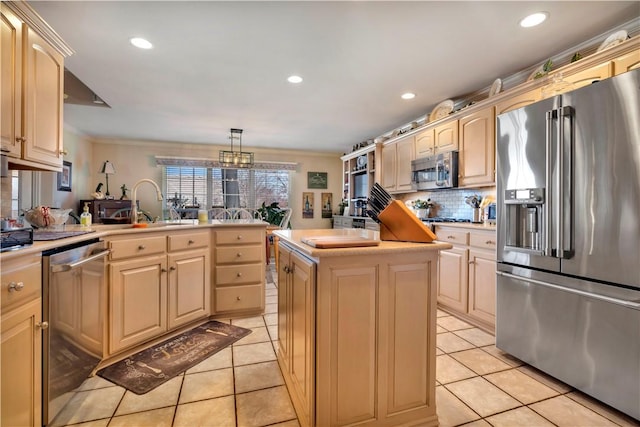 kitchen featuring light countertops, tasteful backsplash, appliances with stainless steel finishes, and a sink