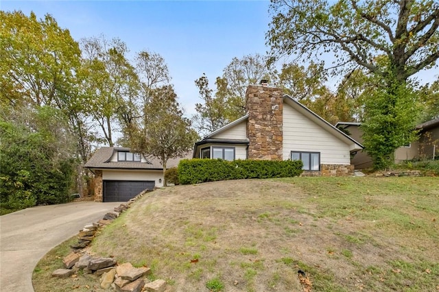 view of property exterior with an attached garage, a lawn, driveway, and a chimney