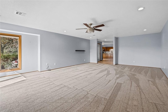 unfurnished living room with light carpet, visible vents, recessed lighting, and ceiling fan