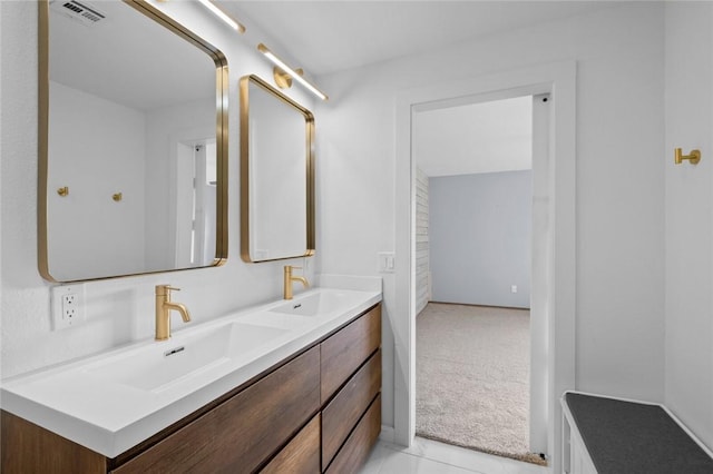 bathroom featuring a sink, visible vents, and double vanity