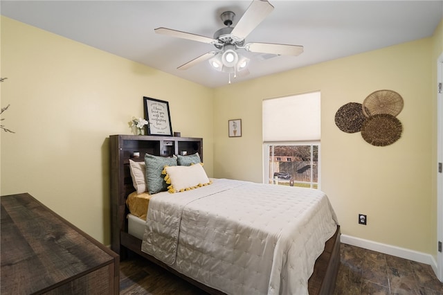 bedroom featuring a ceiling fan and baseboards