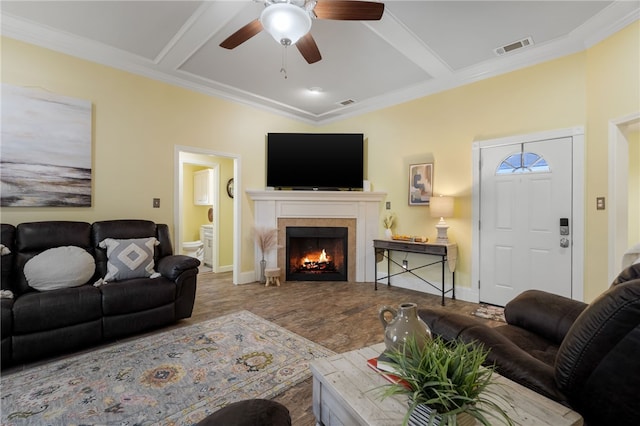 living area with baseboards, visible vents, coffered ceiling, ceiling fan, and a tiled fireplace