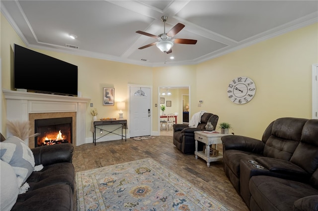 living area with wood finished floors, visible vents, coffered ceiling, ceiling fan, and a tiled fireplace