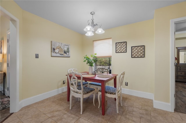 dining space with a notable chandelier, baseboards, and light tile patterned floors