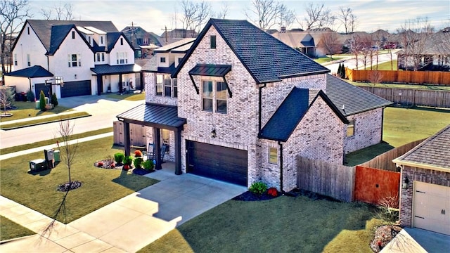 view of front facade with driveway, fence, a residential view, a garage, and brick siding