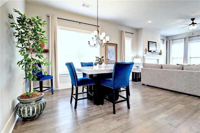 dining area with a chandelier, light wood-style flooring, recessed lighting, a ceiling fan, and baseboards