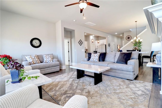 1431 Cave Stream Dr, Cave Springs, AR 72718 - living area featuring a ceiling fan, wood finished floors, a chandelier, and baseboards