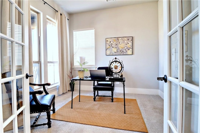 office with french doors, carpet, and baseboards