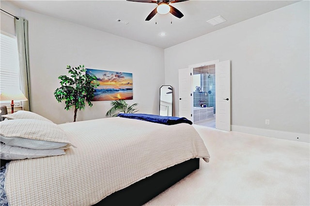 carpeted bedroom with visible vents, connected bathroom, a ceiling fan, and baseboards