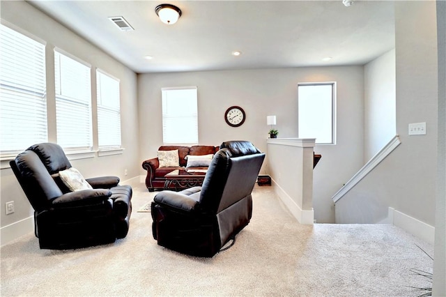 living area featuring visible vents, recessed lighting, baseboards, and carpet