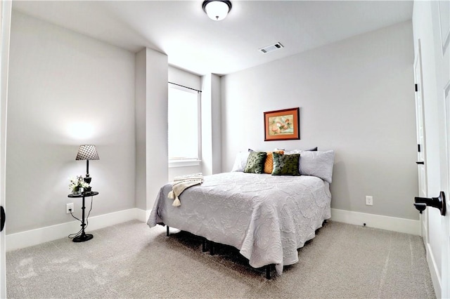 carpeted bedroom featuring visible vents and baseboards