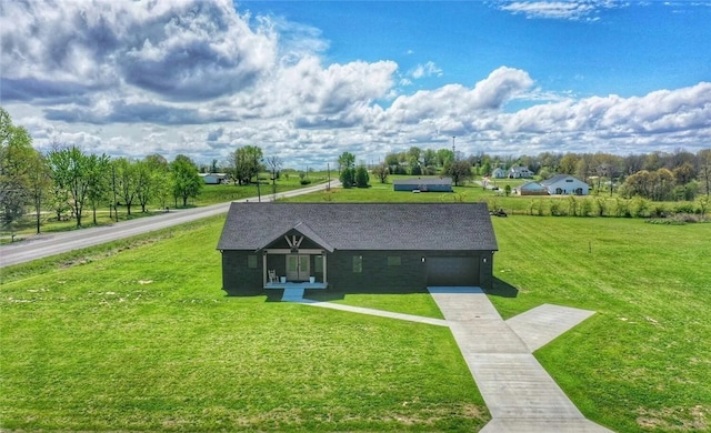 view of front of house featuring concrete driveway, an attached garage, and a front lawn