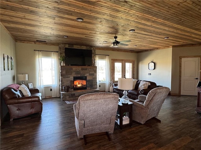 living room with a stone fireplace, wood ceiling, ceiling fan, and dark wood-style flooring