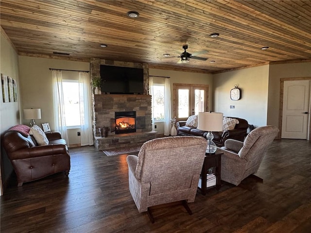 living room featuring a fireplace, wood ceiling, dark wood-type flooring, and a ceiling fan