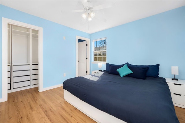 bedroom with light wood-style flooring, baseboards, a closet, and ceiling fan