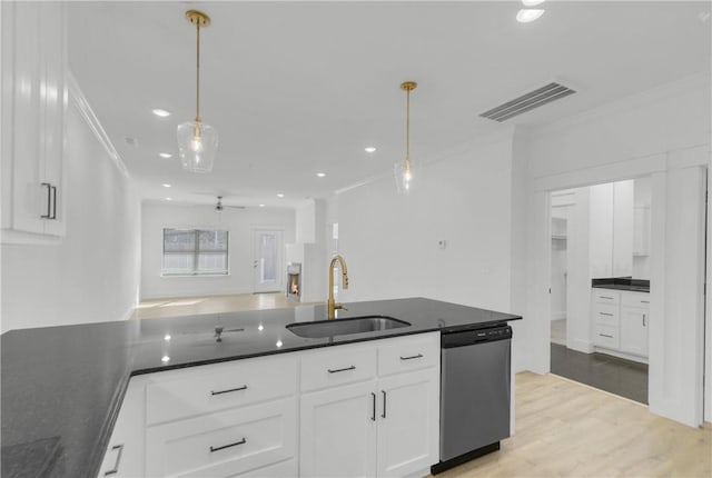 kitchen featuring visible vents, a sink, white cabinetry, light wood-style floors, and dishwasher