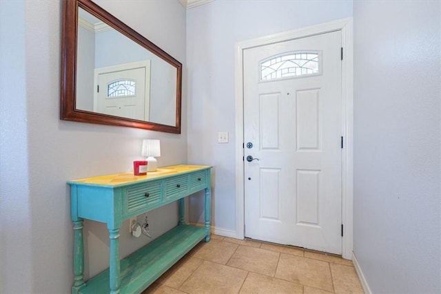 foyer featuring light tile patterned flooring and baseboards