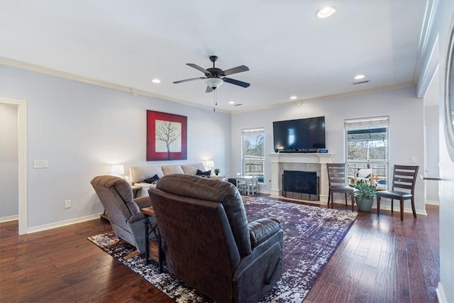 living area featuring a wealth of natural light, baseboards, and hardwood / wood-style floors