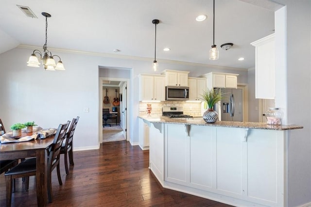 kitchen featuring visible vents, light stone counters, backsplash, stainless steel appliances, and a chandelier