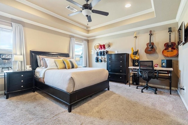 carpeted bedroom featuring visible vents, ornamental molding, a ceiling fan, baseboards, and a raised ceiling