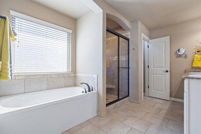 full bathroom with tile patterned floors, a shower stall, vanity, and a garden tub