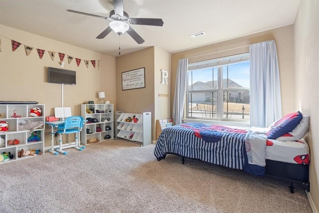 bedroom with visible vents, carpet, and a ceiling fan