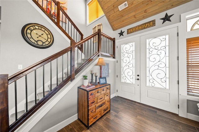 entrance foyer with visible vents, dark wood finished floors, stairs, wood ceiling, and french doors