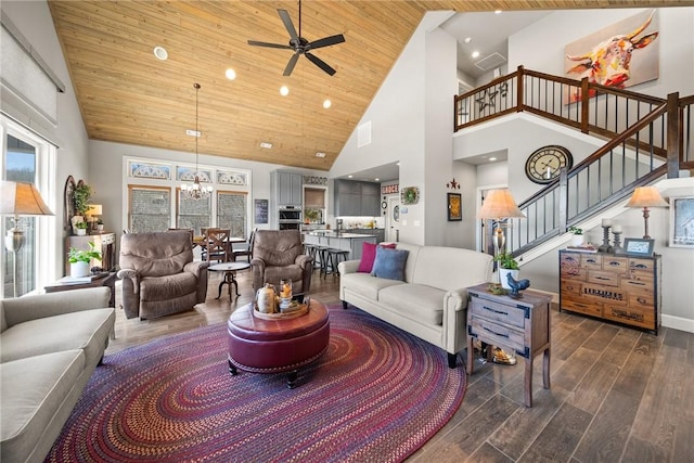 living room with plenty of natural light, dark wood-style flooring, stairs, wood ceiling, and ceiling fan with notable chandelier