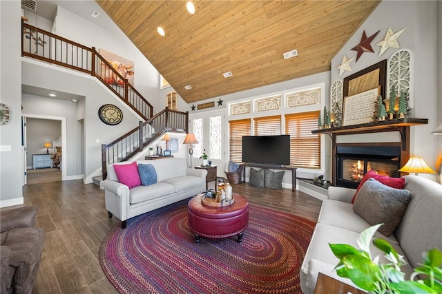 living area with a glass covered fireplace, wooden ceiling, stairway, and wood finished floors