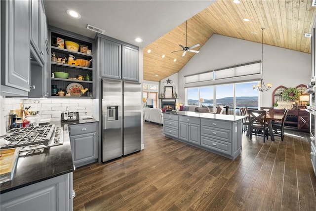 kitchen featuring visible vents, gray cabinets, stainless steel appliances, wood ceiling, and ceiling fan with notable chandelier