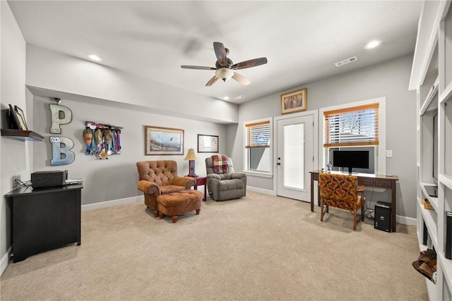 office with baseboards, visible vents, carpet floors, and ceiling fan