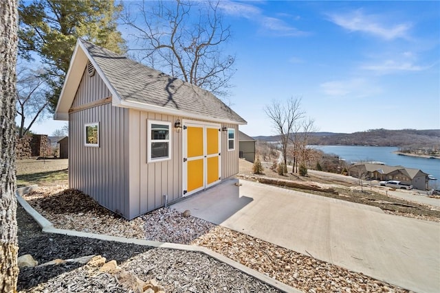 view of shed with a water view