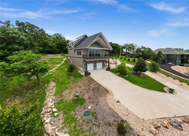 14137 Ozark Dr, Garfield, AR 72732 - view of front of house with a garage, a front yard, and concrete driveway