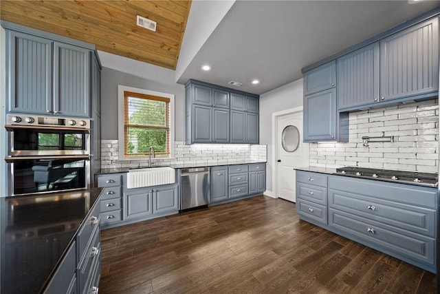 14137 Ozark Dr, Garfield, AR 72732 - kitchen featuring appliances with stainless steel finishes, gray cabinets, recessed lighting, backsplash, and dark wood-type flooring