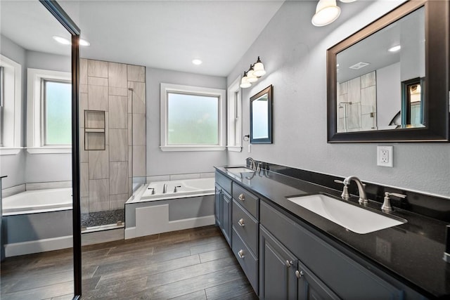14137 Ozark Dr, Garfield, AR 72732 - full bath featuring a garden tub, double vanity, a stall shower, wood finished floors, and recessed lighting