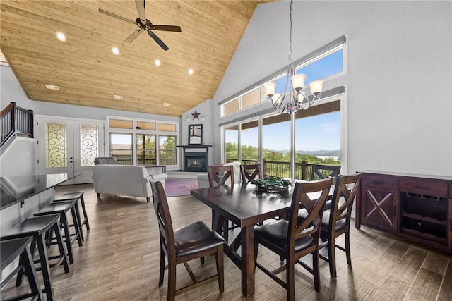 14137 Ozark Dr, Garfield, AR 72732 - dining area featuring high vaulted ceiling, wood ceiling, wood finished floors, a glass covered fireplace, and a ceiling fan
