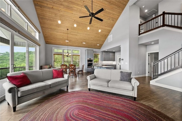 14137 Ozark Dr, Garfield, AR 72732 - living area featuring high vaulted ceiling, a chandelier, stairway, dark wood-type flooring, and a ceiling fan