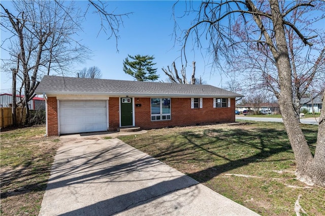 view of front of house with brick siding, driveway, an attached garage, and a front yard