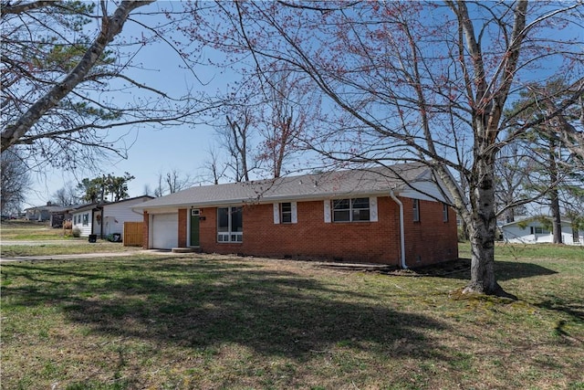 ranch-style home featuring brick siding, crawl space, a front yard, and an attached garage